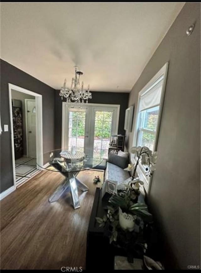 dining area with hardwood / wood-style flooring and a chandelier