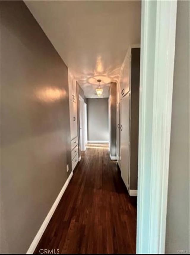 corridor featuring dark hardwood / wood-style flooring