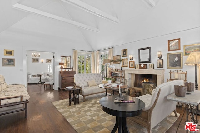 living room with wood-type flooring, beam ceiling, a chandelier, and high vaulted ceiling