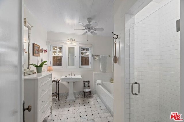 bathroom featuring ceiling fan, separate shower and tub, and sink