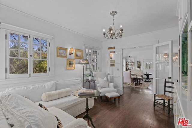 living room featuring crown molding, dark hardwood / wood-style flooring, a chandelier, and french doors