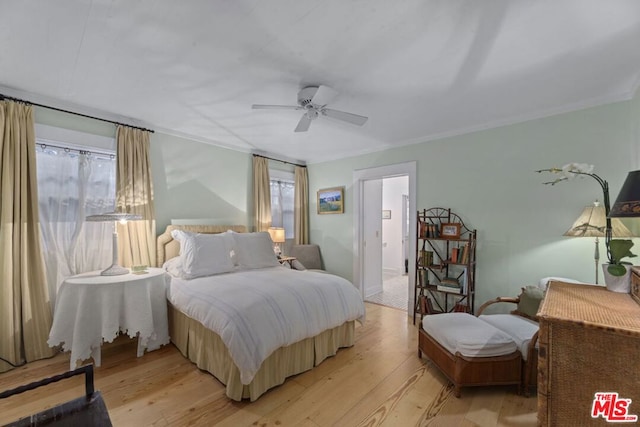 bedroom featuring ceiling fan, ornamental molding, and light hardwood / wood-style floors