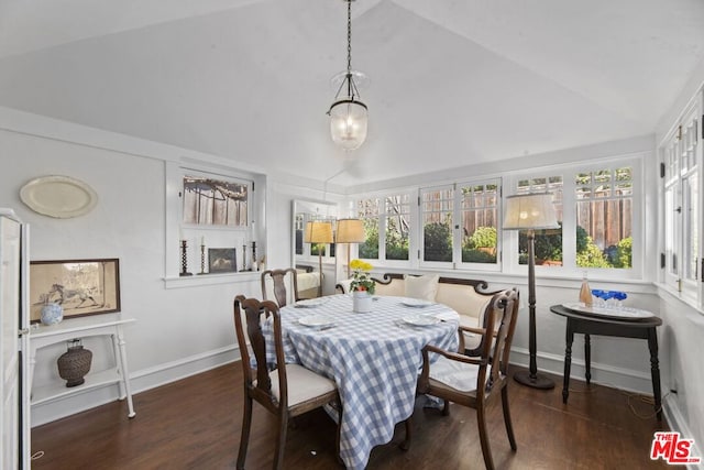 dining space featuring lofted ceiling and dark hardwood / wood-style flooring