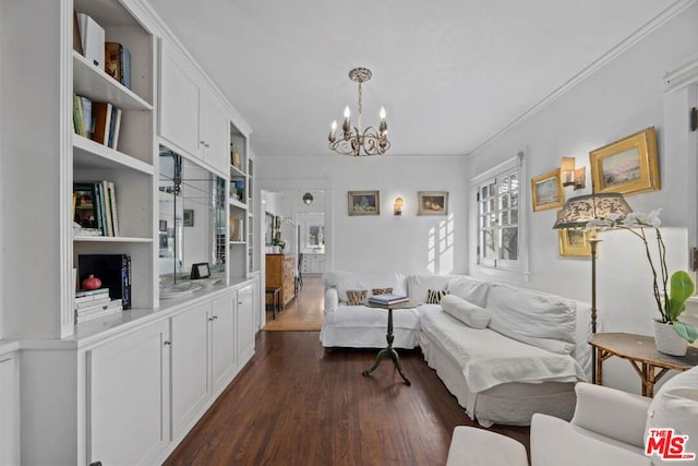 living room with ornamental molding, dark hardwood / wood-style floors, and a notable chandelier