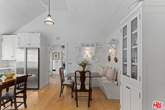 dining space with vaulted ceiling, wooden ceiling, and light wood-type flooring