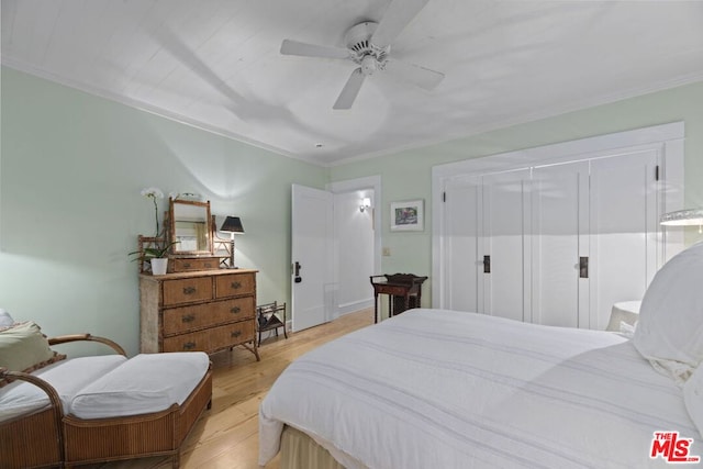 bedroom with crown molding, ceiling fan, and light hardwood / wood-style floors