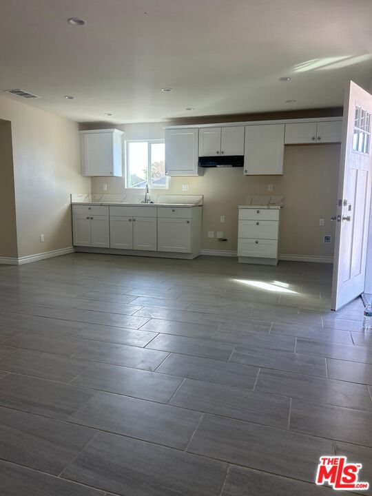 kitchen with white cabinetry and sink