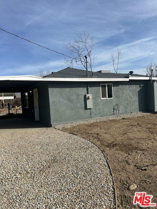 view of side of home featuring a carport