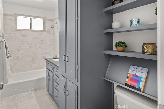 full bathroom with vanity, toilet, and tiled shower / bath combo