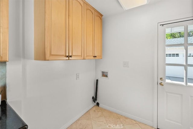 washroom featuring light tile patterned floors, hookup for a washing machine, and cabinets