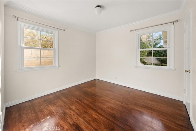 empty room with dark wood-type flooring, ornamental molding, and a healthy amount of sunlight