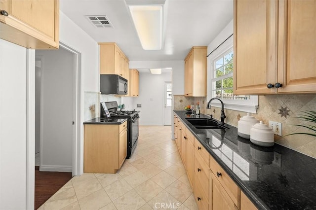 kitchen featuring tasteful backsplash, sink, light brown cabinetry, and black appliances