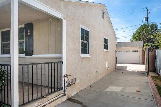 view of property exterior featuring a garage and an outbuilding