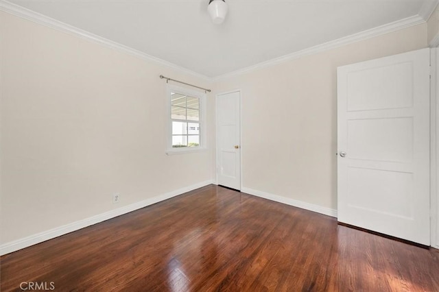 empty room with crown molding and dark hardwood / wood-style floors