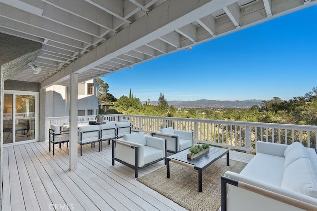 deck with a mountain view and an outdoor hangout area