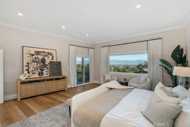 bedroom featuring crown molding, access to outside, and light hardwood / wood-style floors