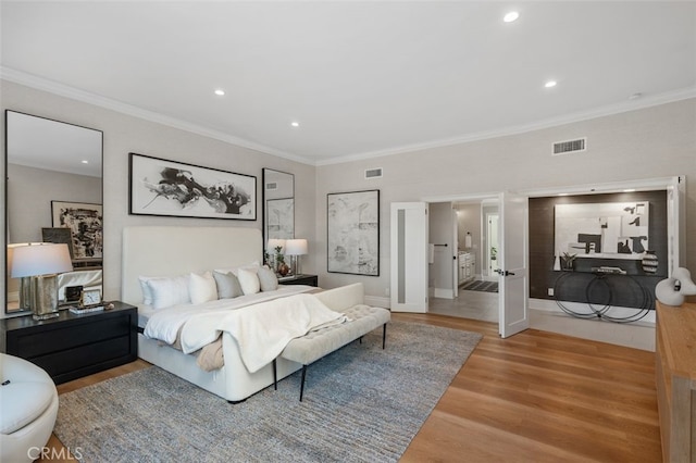 bedroom featuring wood-type flooring and ornamental molding