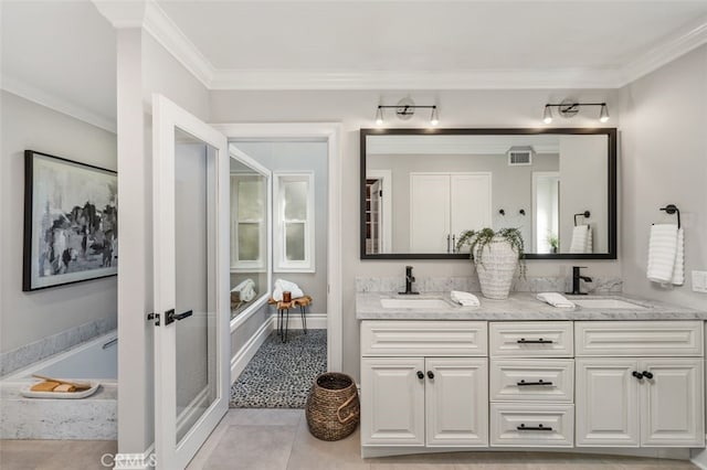 bathroom with tile patterned flooring, crown molding, tiled tub, and vanity