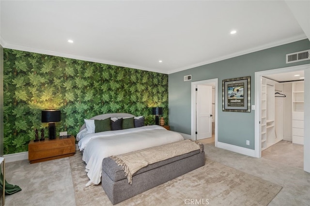 bedroom with ensuite bath, ornamental molding, and light colored carpet