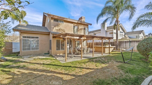 rear view of house featuring a patio, a pergola, a yard, and a jacuzzi