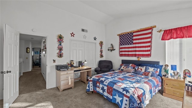 carpeted bedroom featuring lofted ceiling