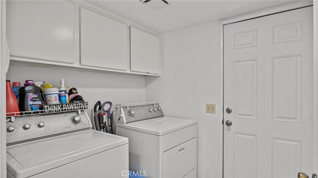 clothes washing area featuring separate washer and dryer and cabinets