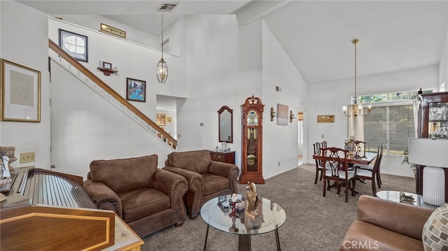 carpeted living room with high vaulted ceiling and a chandelier