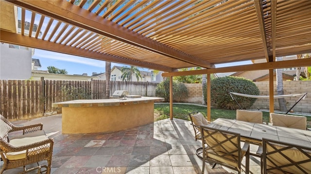 view of patio / terrace featuring a pergola and an outdoor kitchen