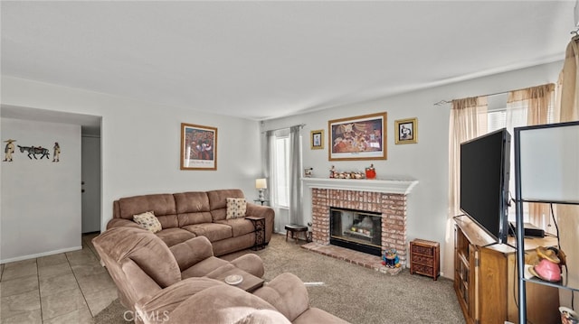 living room featuring a brick fireplace and a healthy amount of sunlight