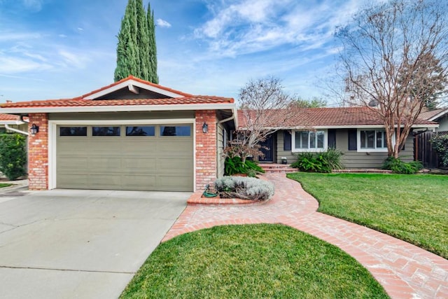 view of front of house featuring a garage and a front lawn