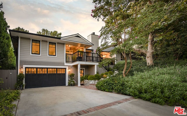 view of front of home featuring a garage and a balcony