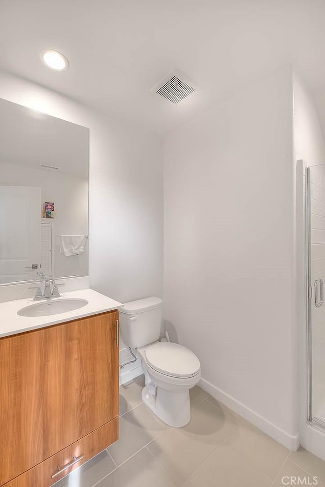 bathroom with walk in shower, vanity, toilet, and tile patterned flooring