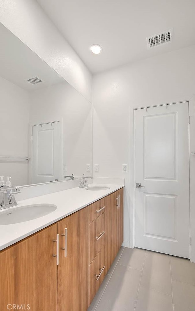 bathroom featuring tile patterned flooring and vanity