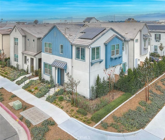 view of front of property featuring solar panels