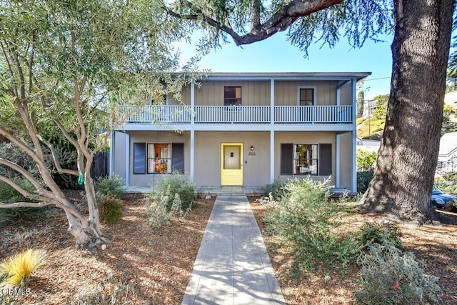 view of property with a balcony and a porch