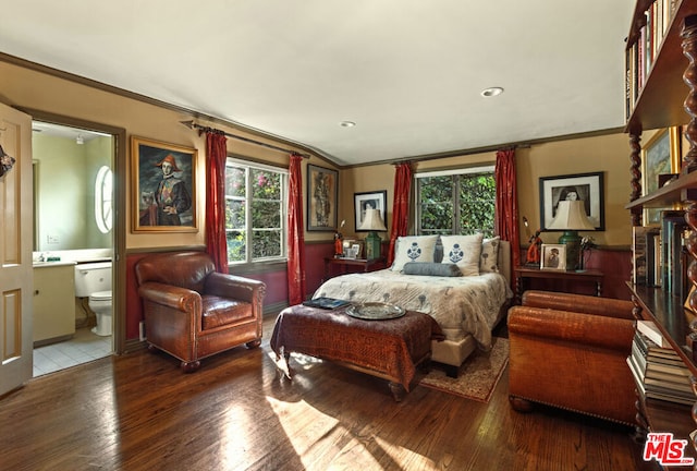 bedroom featuring connected bathroom, ornamental molding, and hardwood / wood-style floors