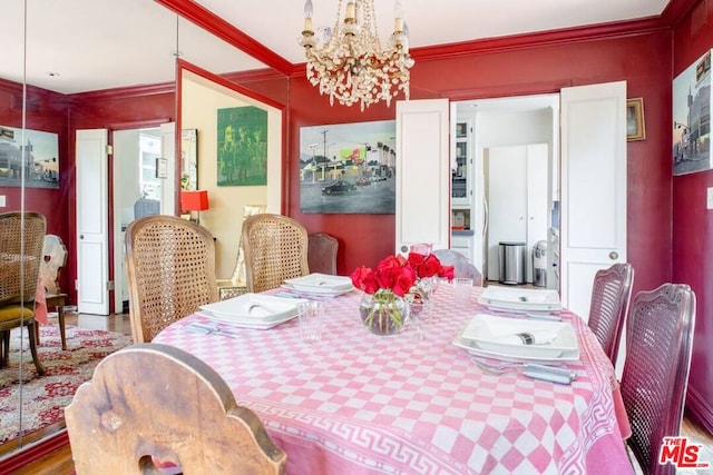 dining area with crown molding and a chandelier