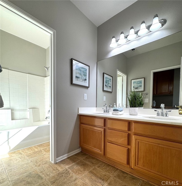 bathroom featuring vanity and shower / tub combination