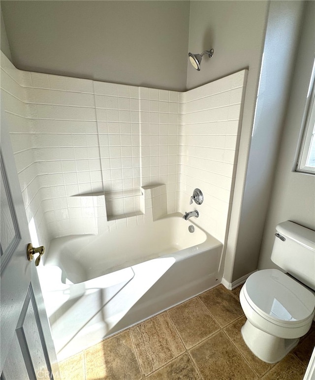 bathroom with toilet, tub / shower combination, and tile patterned flooring