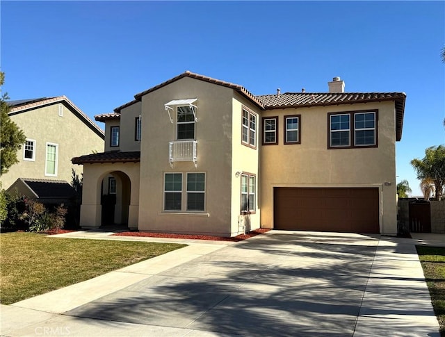 mediterranean / spanish-style home featuring a garage and a front lawn