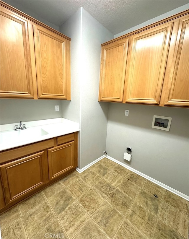 laundry room with cabinets, sink, and washer hookup