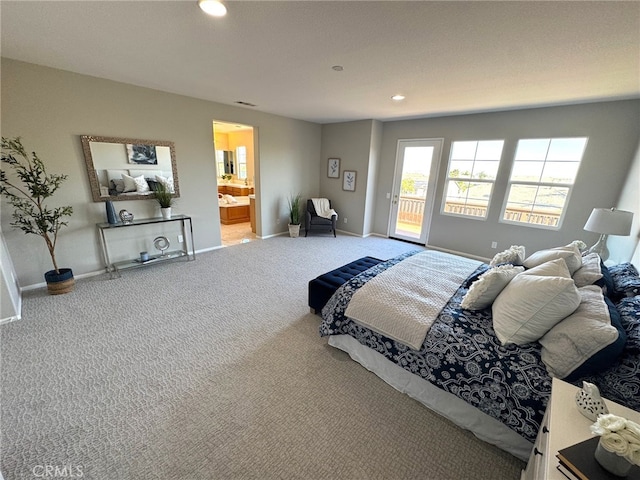 bedroom featuring carpet floors, ensuite bath, and access to outside