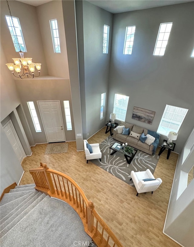 foyer entrance featuring hardwood / wood-style flooring, a wealth of natural light, and a chandelier