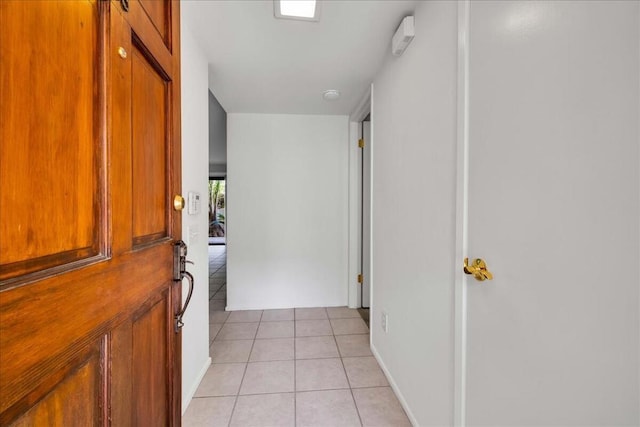 hall with light tile patterned floors