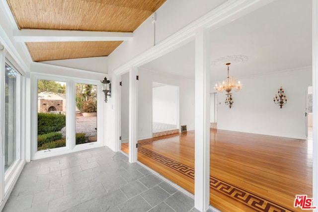 interior space with lofted ceiling with beams, a notable chandelier, and wooden ceiling