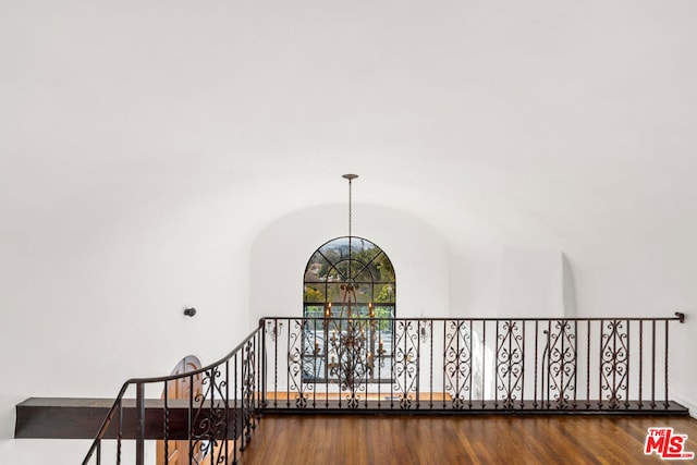 interior details with hardwood / wood-style flooring and a chandelier