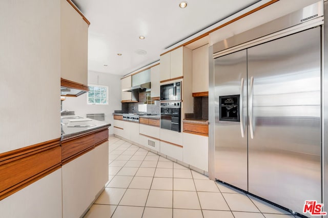 kitchen with white cabinetry, light tile patterned flooring, and black appliances