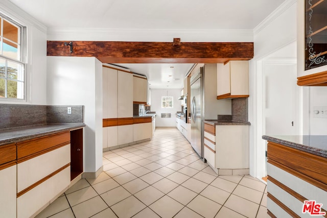 kitchen with stainless steel built in refrigerator, white cabinetry, crown molding, light tile patterned floors, and backsplash