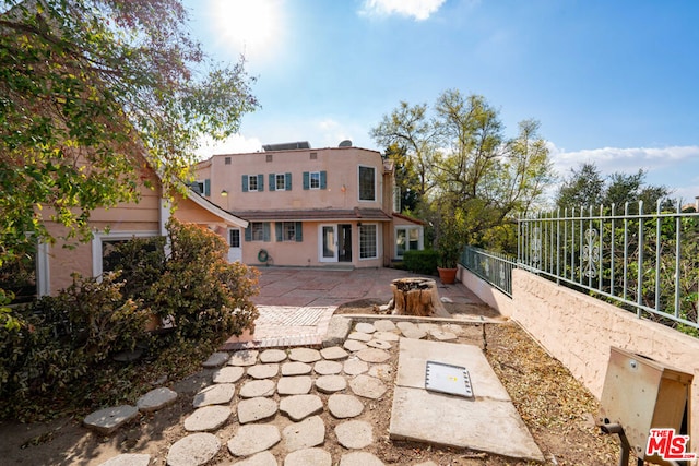 back of property with a patio