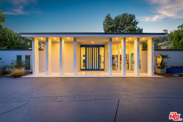 back house at dusk with a patio